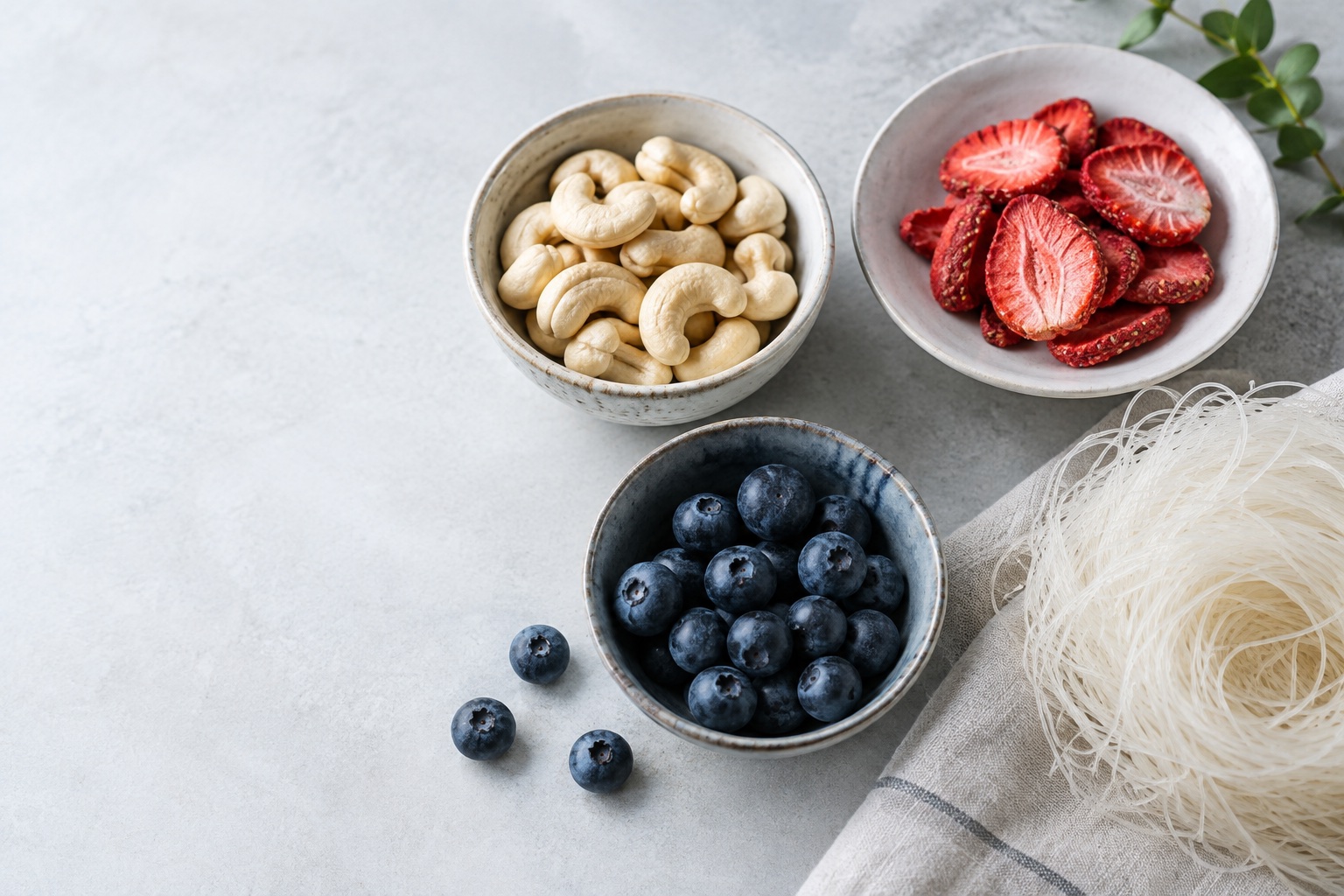 Illustration of cashews, freeze-dried strawberries, blueberries, and glass noodles
